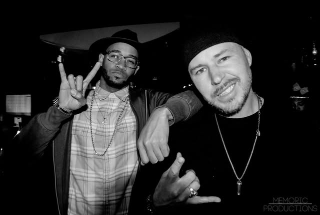 Black and white candid photograph of Hypnautic smiling with a friend