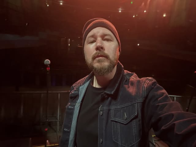 Hypnautic in a denim jacket and knit cap at a venue